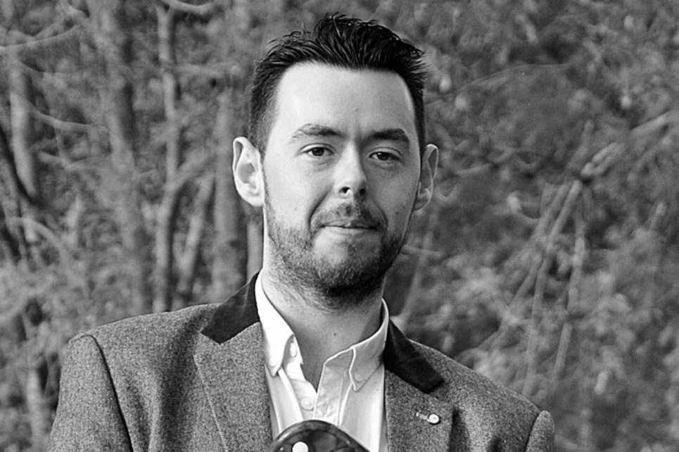 A black and white portrait photograph of Daithi Gormley