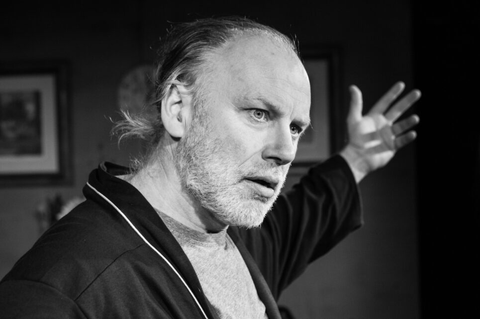 Black and white image of actor performing