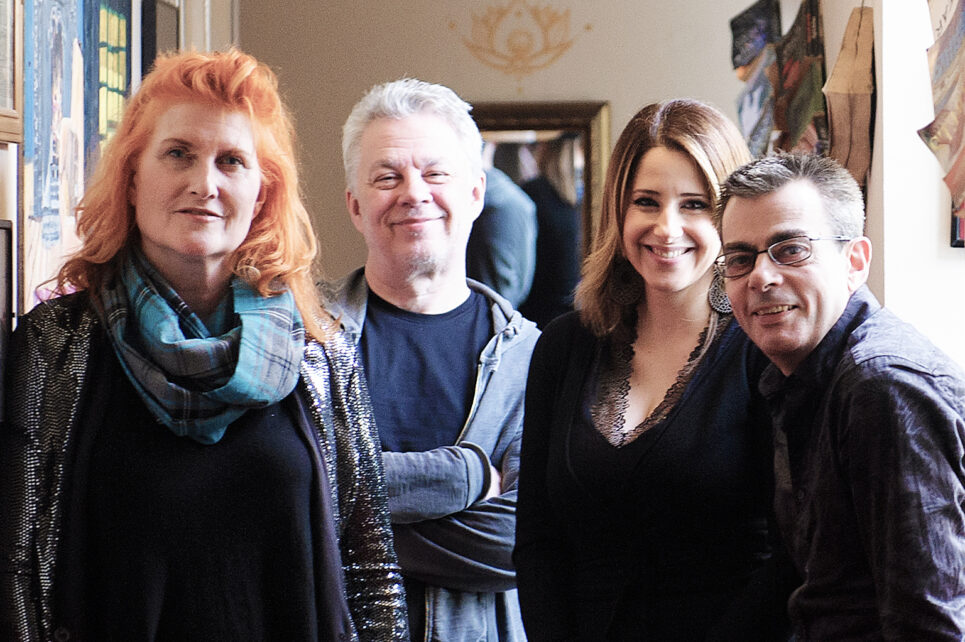 Four people smiling for the camera