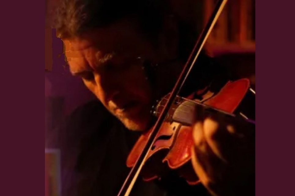 The cover image for Seamie O'Dowd's album "Futher Down the Line". The image at the centre shows Seamie playing a violin. Above the image is the text with his name and the album title.