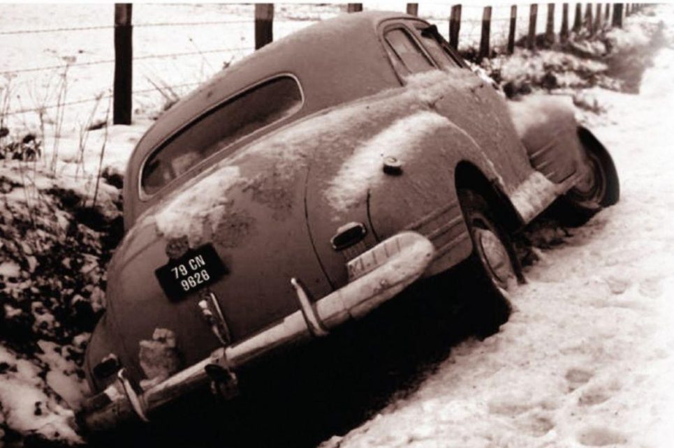 Old broken-down car stuck in a ditch