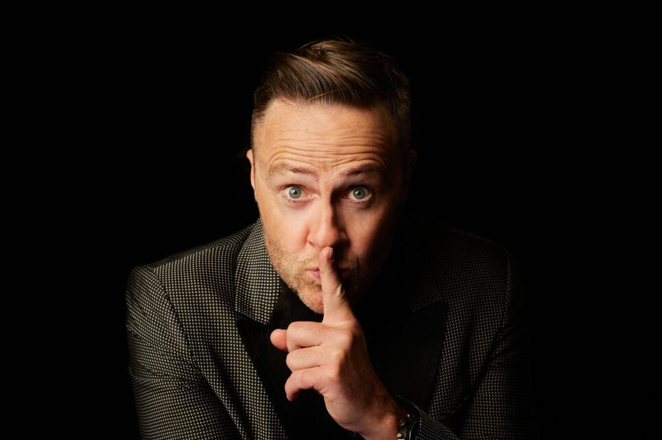 Man putting his finger to his lips