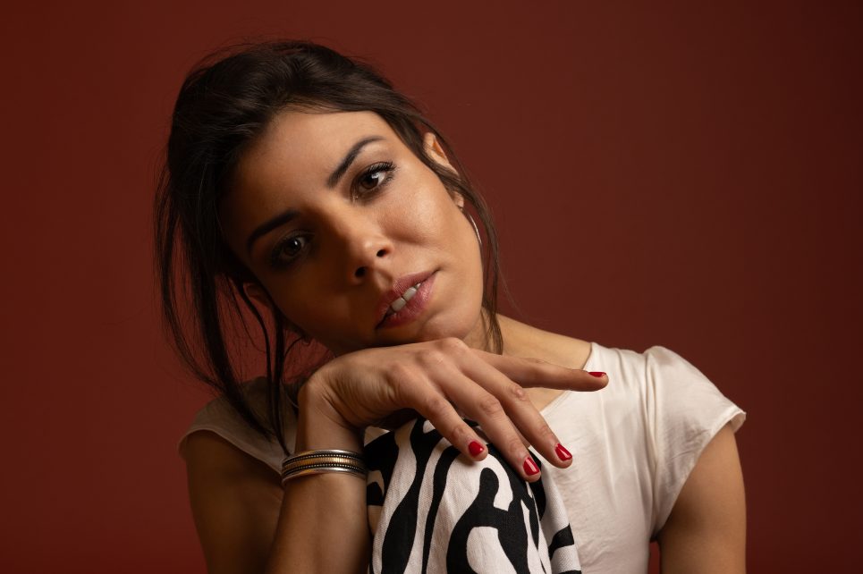 Close up image of Chilean-born saxophonist Melissa Aldana against a brown backdrop