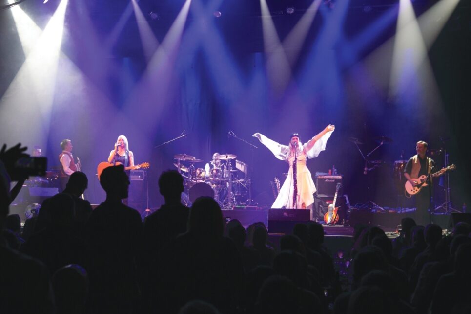 Singers are on stage performing in front of an audience