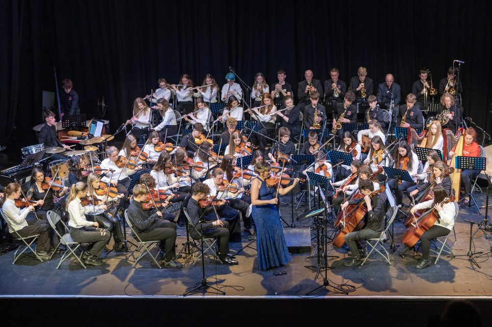 A photograph of the Sligo Academy of Music orchestra performing on stage