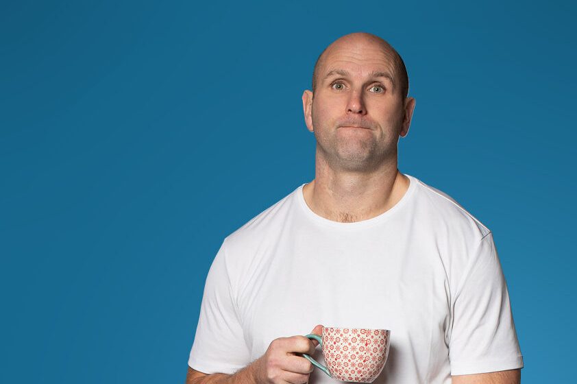 A photograph of Rory O'Connor with a blue background
