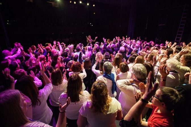 Crowd clapping along to performer