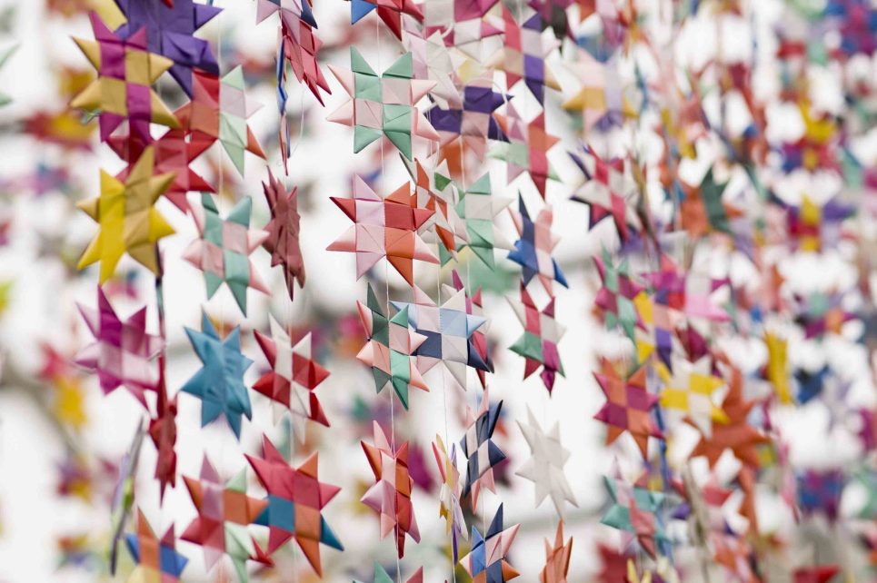 Hundreds of little hanging colorful cut-out stars