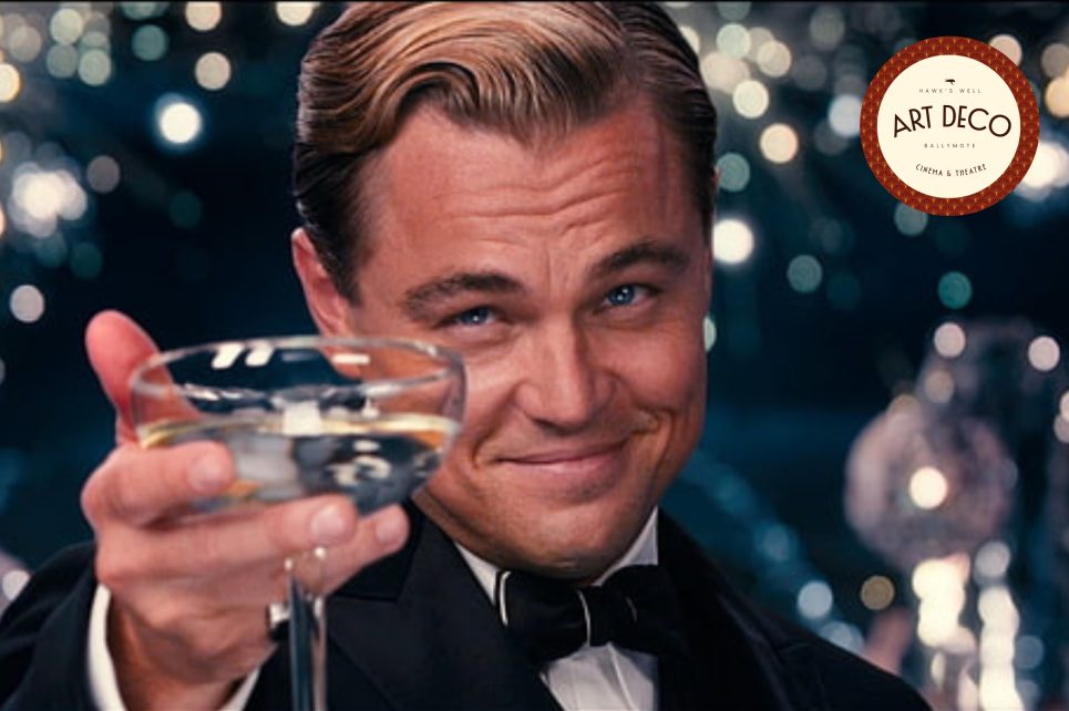 Leonardi DiCaprio holding out a martini glass in Great Gatsby movie poster