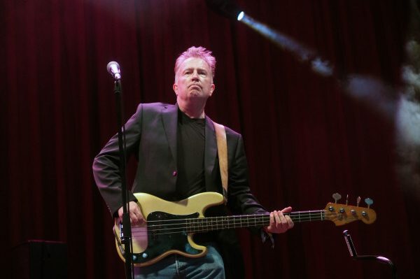 Tom Robinson performing on stage with guitar