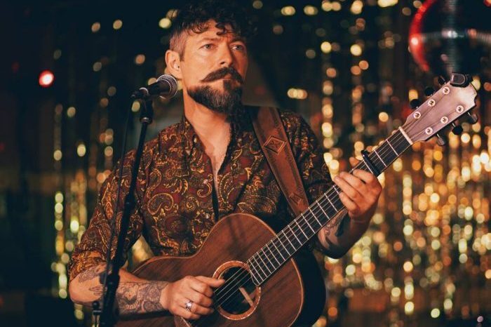 A photograph of Niall McCabe on stage A photograph of Niall McCabe on stage