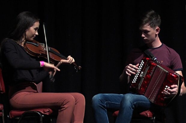 A photograph of Aaron and Ava Glancy playing their instruments A photograph of Aaron and Ava Glancy playing their instruments