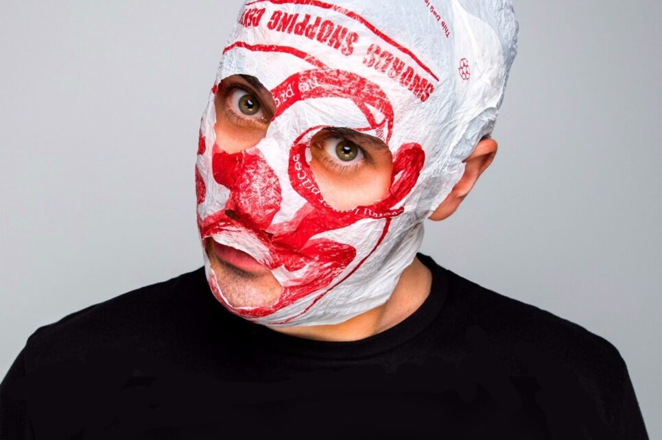 close head shot of man whose face is wrapped in a plastic bag