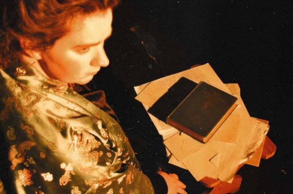 Woman sitting at table with books and papers on it