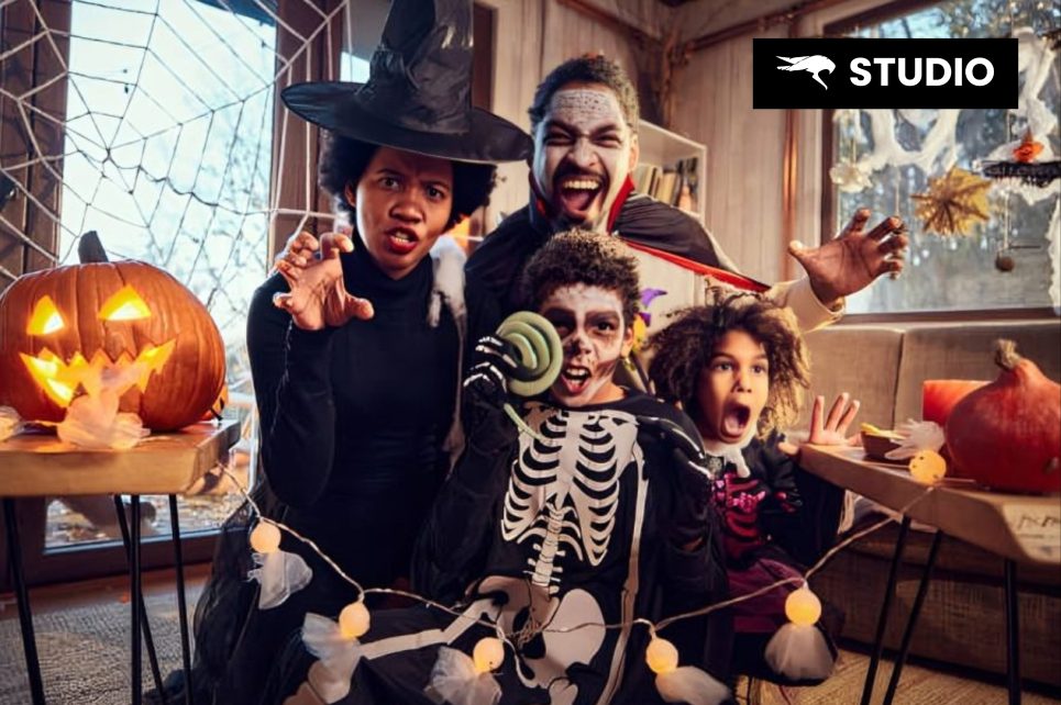 Kids and parents dressed up in Halloween costumes, posing together