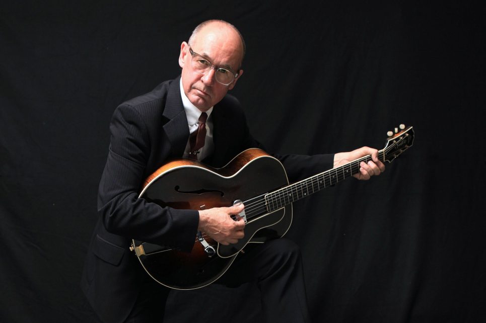Performer Andy Fairweather posing with guitar Performer Andy Fairweather posing with guitar