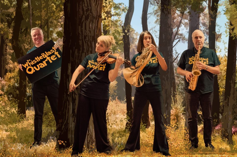 A photograph of the Whistleblast Quartet playing their instruments in a forest.