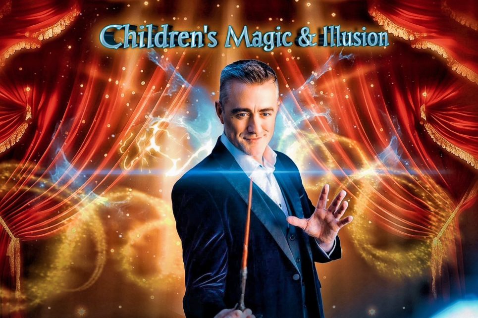 A magician in a suit is holding a magic wand.